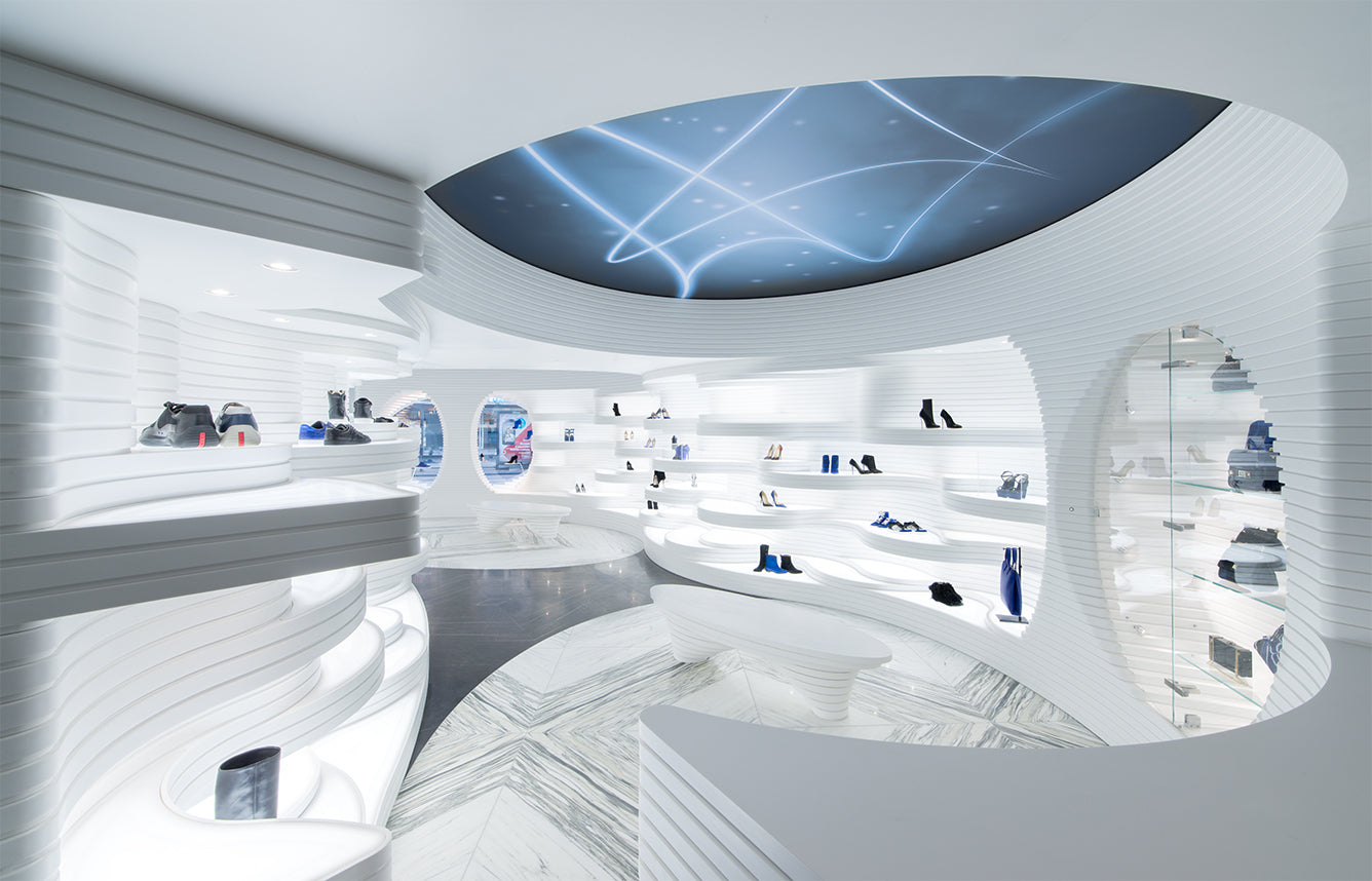 White futuristic Shoebaloo interior with curved illuminated shelves and shoes on display