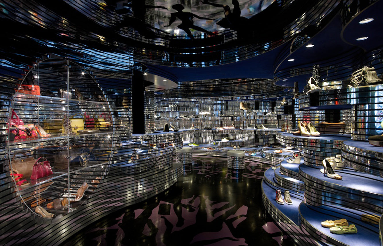 Dark blue Shoebaloo store interior with wave-like shelves and shoes on display